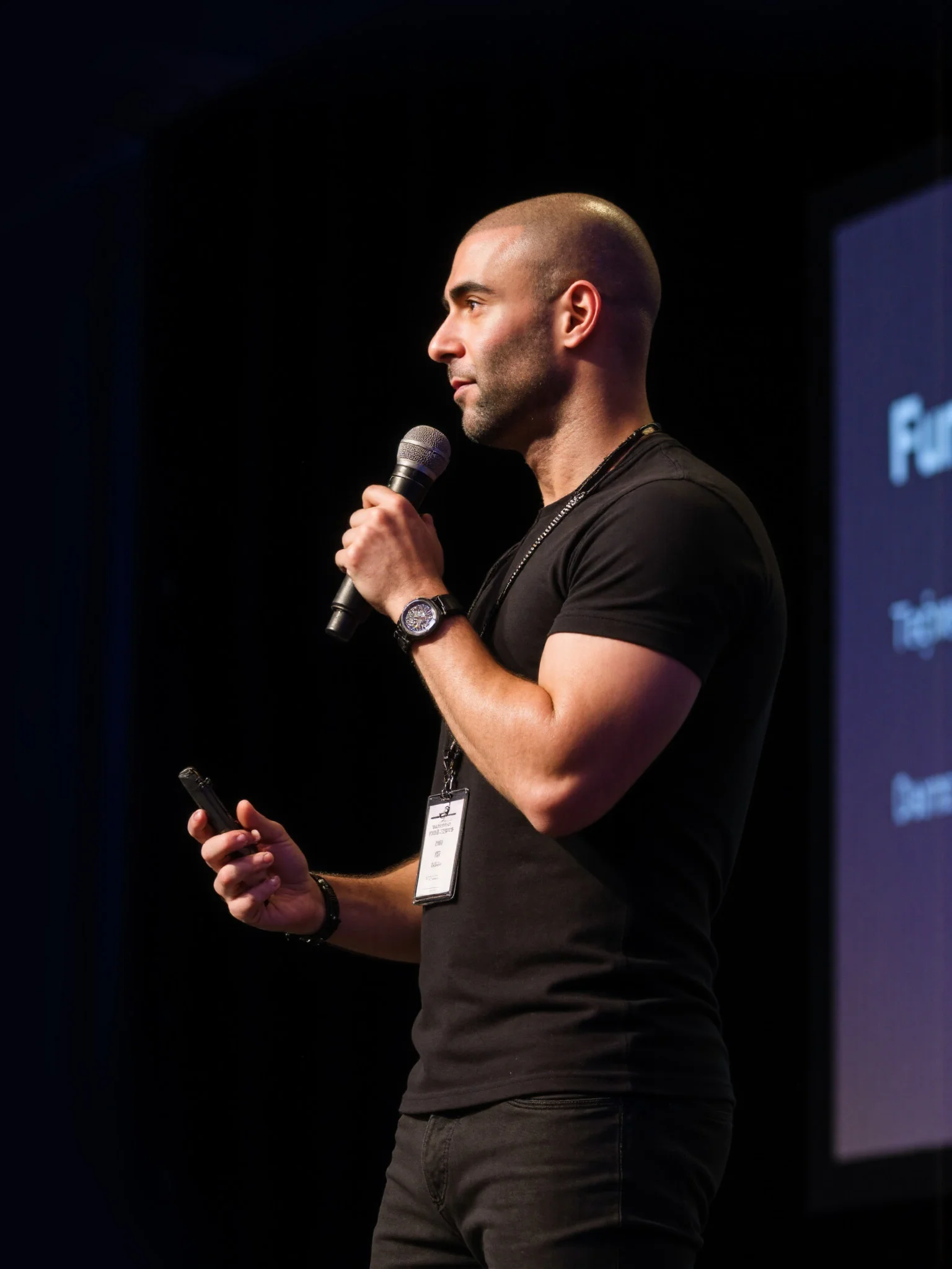 Amir Zarandouz speaking into a microphone at an event